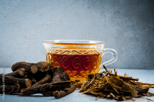 Ayurvedic herb Liquorice root,Licorice root, Mulethi or Glycyrrhiza glabra root and its powder with its tea for detoxifying the body, soothing spasms, easing menstrual cramps, raising blood pressure.