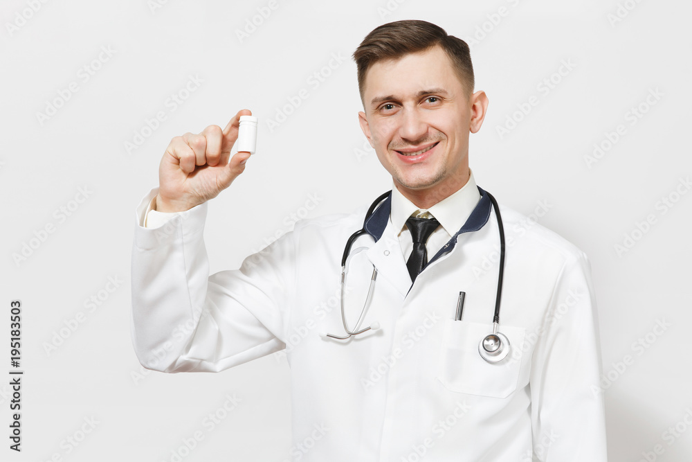 Smiling experienced handsome young doctor man isolated on white background. Male doctor in medical uniform, stethoscope holding bottle with white pills. Healthcare personnel, health, medicine concept. Smiling experienced handsome young doctor man isolated on white background. Male doctor in medical uniform, stethoscope holding bottle with white pills. Healthcare personnel, health, medicine concept.
