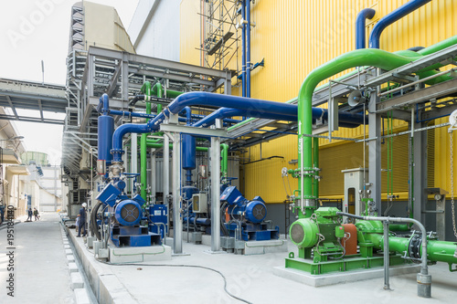 Colorful industrial piping or pipelines. Industrial process piping, valves, fitting, flanges at refinery manufacturing, oil plant or power plant transfer gas, water in the blue sky background