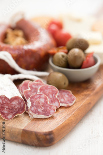 appetizers on wooden board on white wooden background