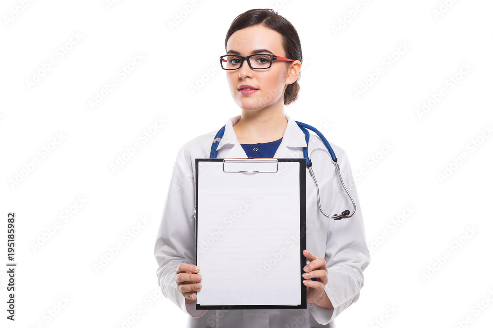 Young woman doctor with stethoscope holding and showing clipboard in her hands in white uniform on white background Young woman doctor with stethoscope holding and showing clipboard in her hands in white uniform on white background