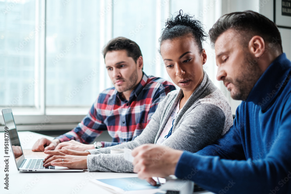 Multi-ethnic colleagues in a coworking office. Multi-ethnic colleagues in a coworking office.