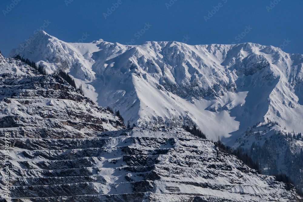 Fototapeta premium Close up of the layered mine at Eisenerz with majestic snow capped peaks in the background