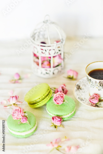 Dessert With Coffee: A Delicate Fresh French Macaroons In Pastel Colors Gift Box Flowers Roses On Light Blue Wooden Background