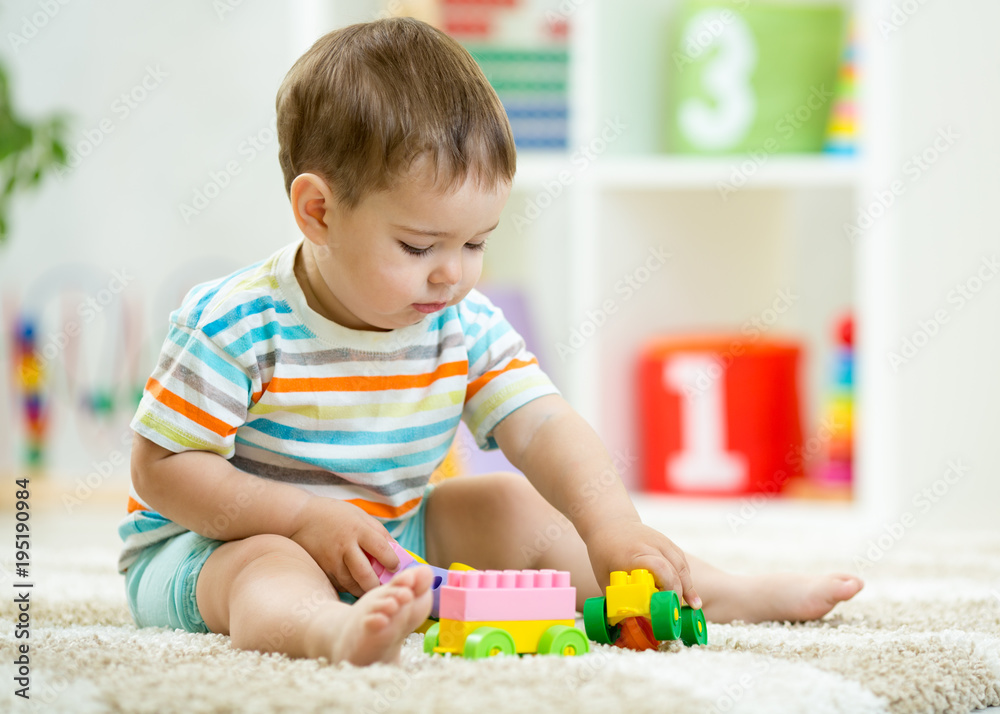 Baby toddler playing wooden toys at home Baby toddler playing wooden toys at home