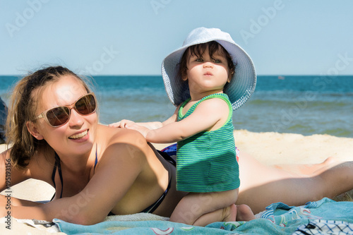 A beautiful mom with a little daughter resting on the Ukrainian beach 2018