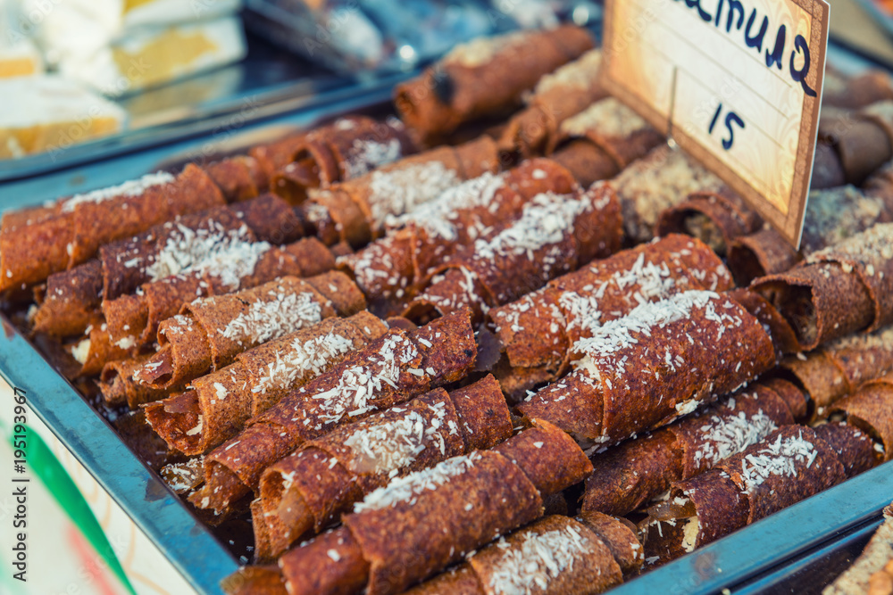 Sweet paste rolls on a street food festival.