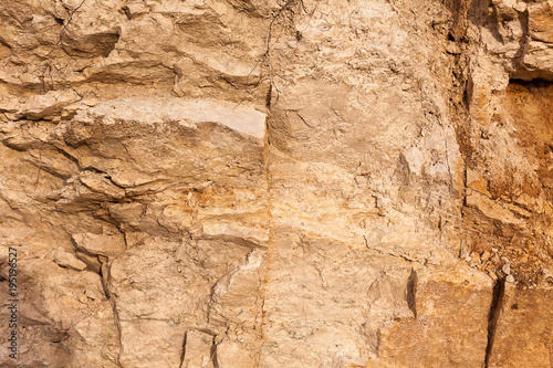 sport, hobby, travelling concept. there is sheer cliff without plants and trees, only stone of ochre colour with rough surface that perfectly fits for mountain climbing