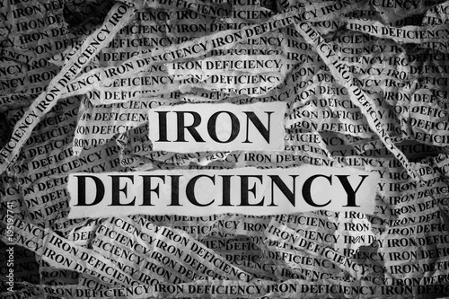 Fotografia Torn pieces of paper with words Iron Deficiency