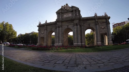 Couple Walking and Watching on Triumphal arch neo-classical monument Puerta de Alcala, Plaza de la Independencia, Madrid, Spain, Europe