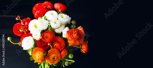 Beautiful fresh bouquet of red, orange and white ranunculus, pions. Blossoming flowers texture, top view, flat lay. Spring or Mothers Day Concept photo