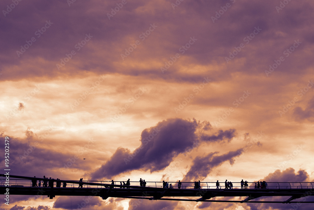 View of London Millennium Bridge with dramatic sky