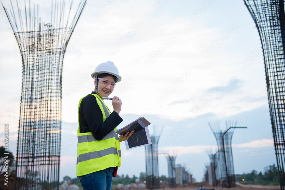 Engineer woman working at site of bridge under construction Engineer woman working at site of bridge under construction