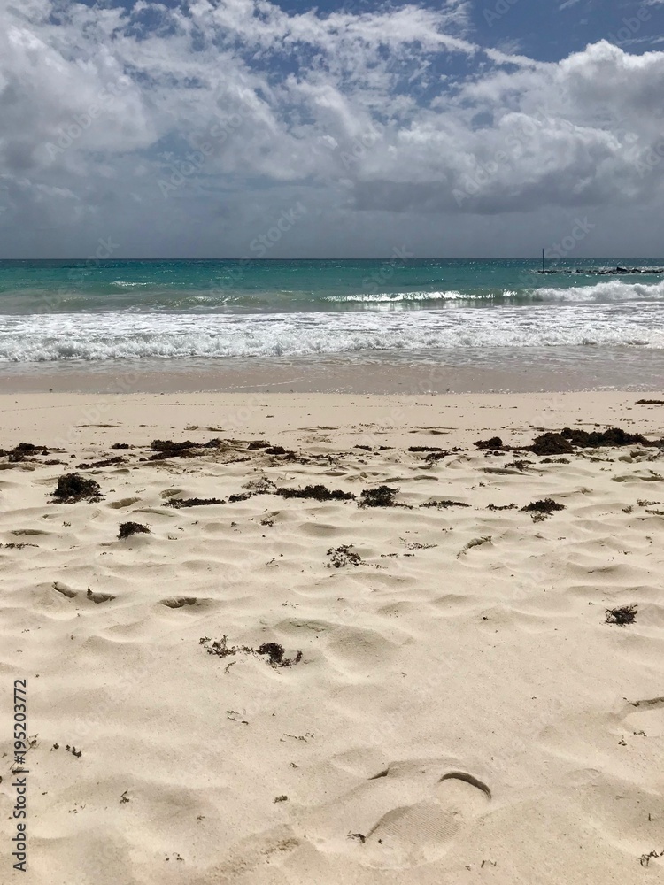 Idyllic and beautiful beach in Barbados (Caribbean island): Nobody, white sand, turquoise water, waves and white clouds Idyllic and beautiful beach in Barbados (Caribbean island): Nobody, white sand, turquoise water, waves and white clouds