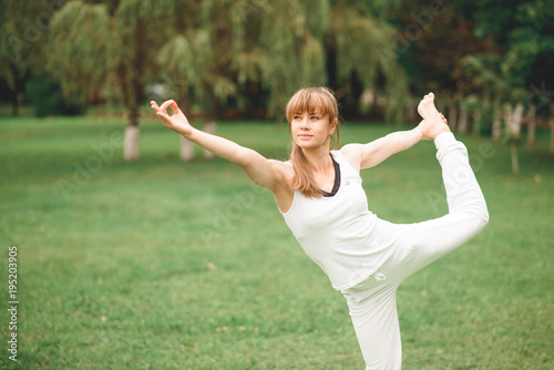 woman does Yoga in the park