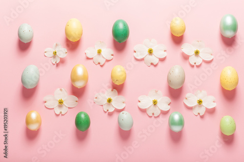 Painted Easter eggs arranged on a pink background