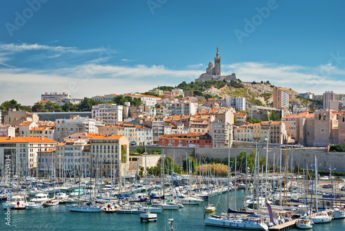 View of the old port of the city of Marseille with Notre Dame de la Garde basilica in the background, French Riviera, France photo
