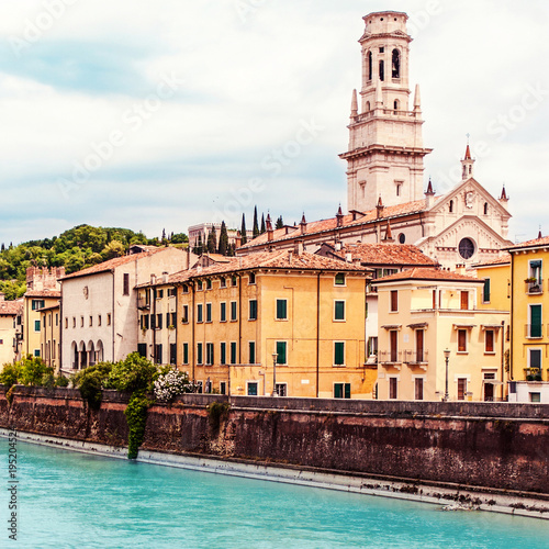 Verona, Italy. Scenery with Adige River and Ponte di Pietra at summer day with blue sky