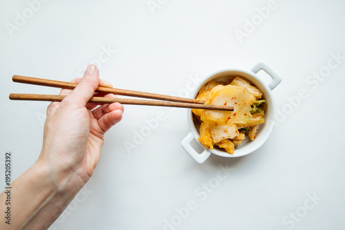 Little bowl of homemade kimchi on white table
