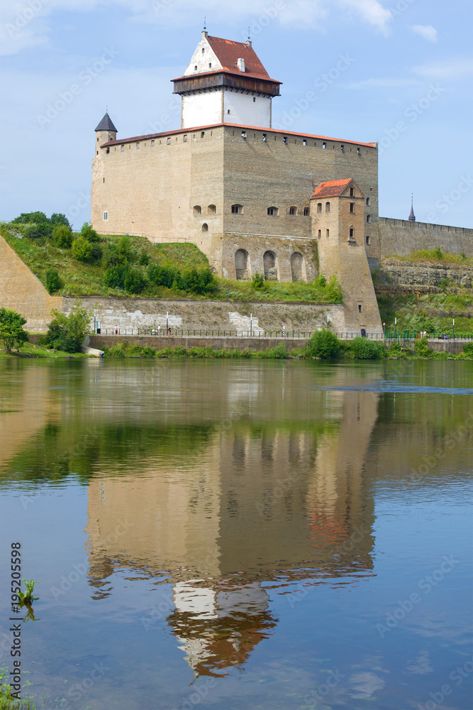 Herman Castle with a reflection on a sunny August day. Narva, Estonia