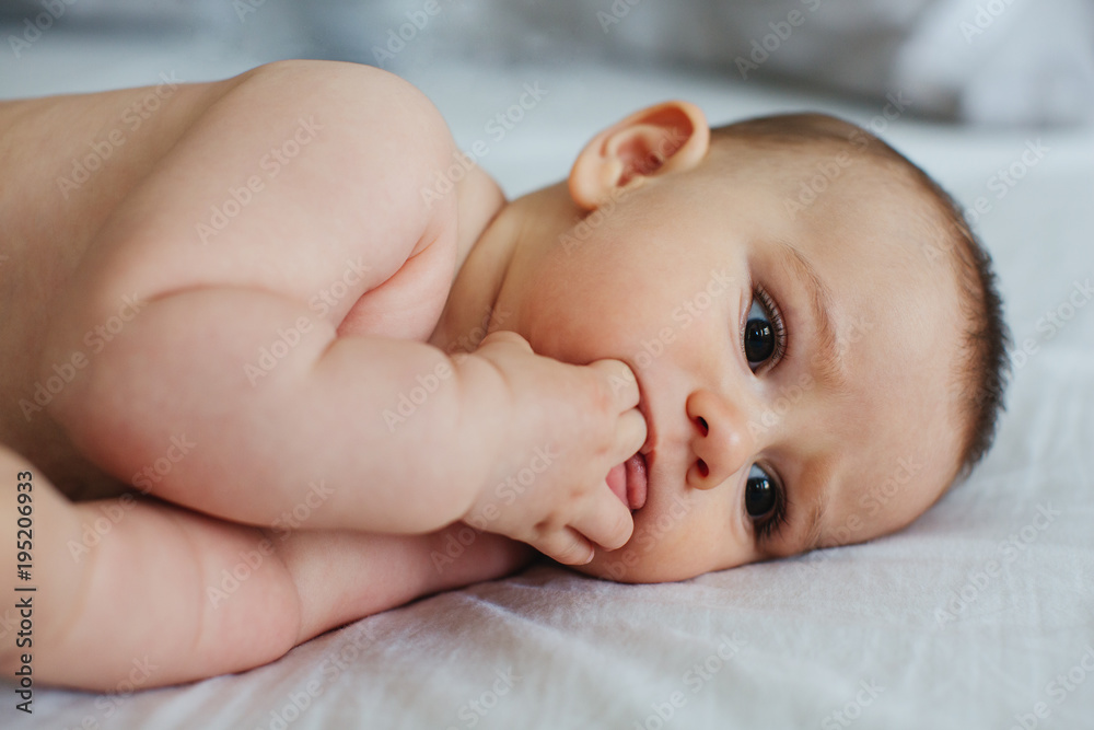 Cute baby on a bed.