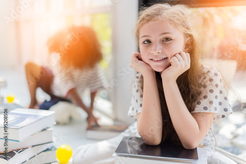 cute happiness kid girl is have fun and joyful moment with study book white room background