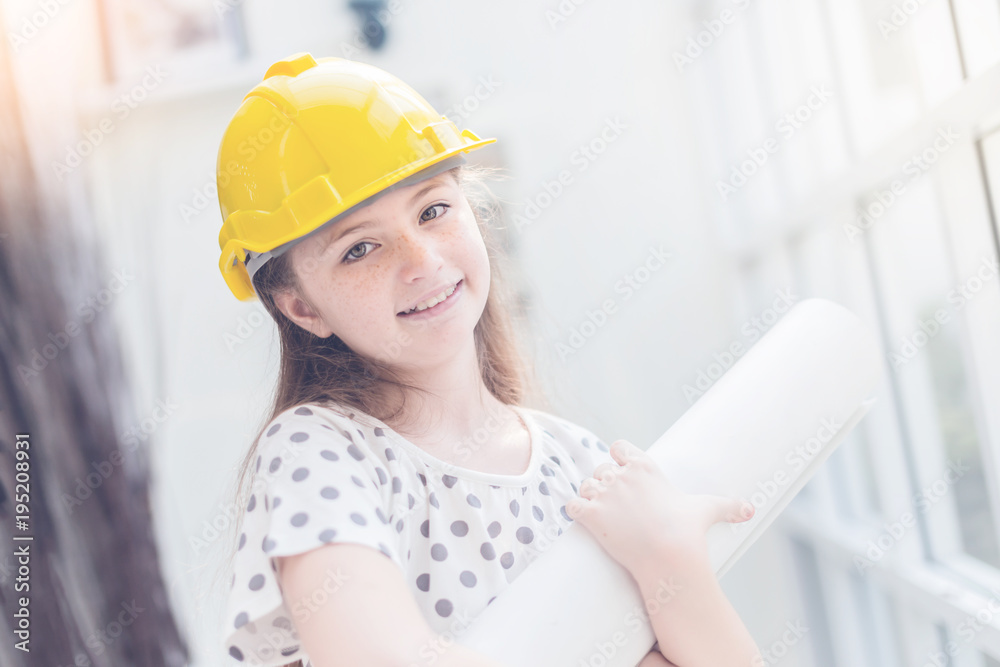 cute and pretty caucasian girl is costume for engineer career with blur background cute and pretty caucasian girl is costume for engineer career with blur background
