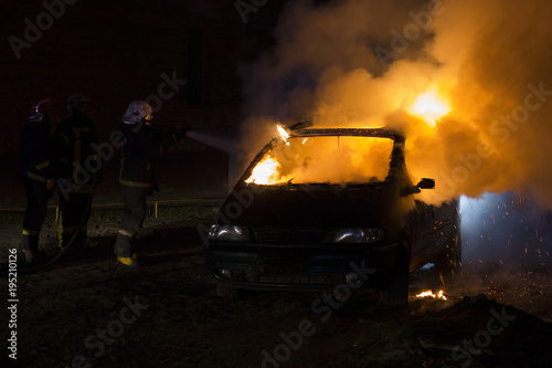 Burning car on the road in the night
