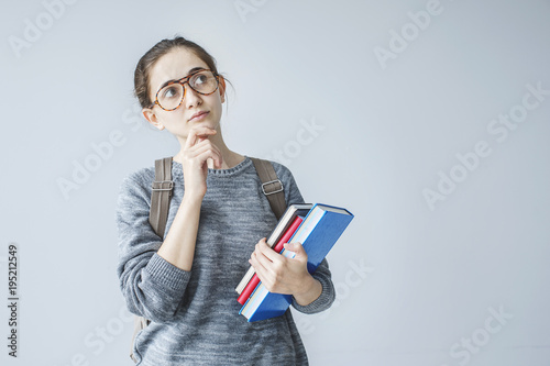 Obraz na plátně Portrait of thinking student girl on grey background