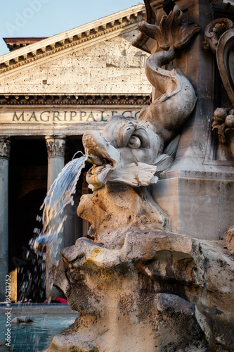 Fountain and the ancient roman Pantheon in Rome at sunset