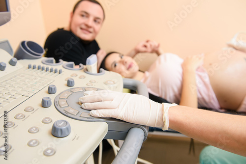 Hands of a doctor who uses medical ultrasound diagnostic machine