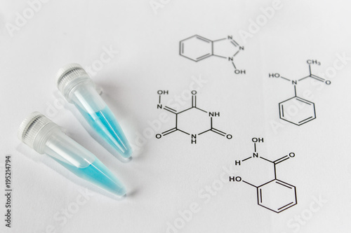 Eppendorfs with a solution of blue laccase enzyme and chemical formulas of substrates. 