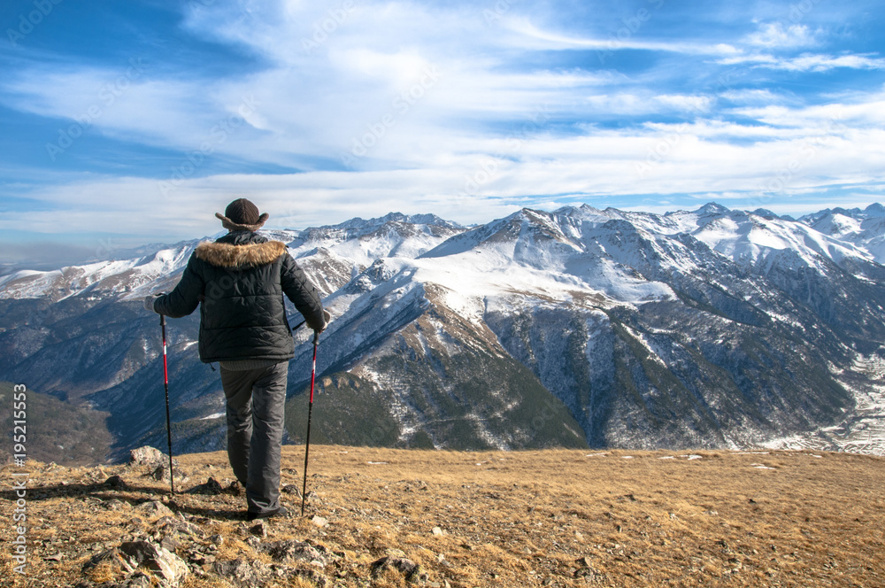 Sunny slope covered with snow and man climbing with trekking poles. Sunny slope covered with snow and man climbing with trekking poles.