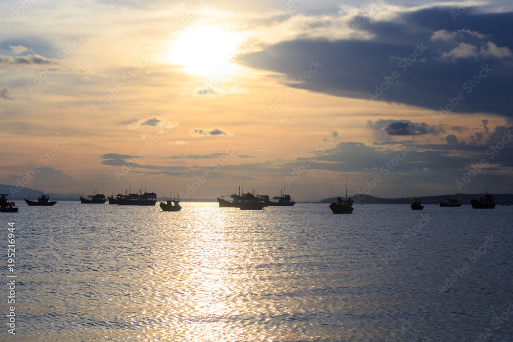 Vietnamese fishing boat silhouettes in sea at sunset Vietnamese fishing boat silhouettes in sea at sunset