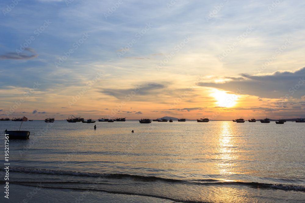 Vietnamese fishing boat silhouettes in sea at sunset Vietnamese fishing boat silhouettes in sea at sunset