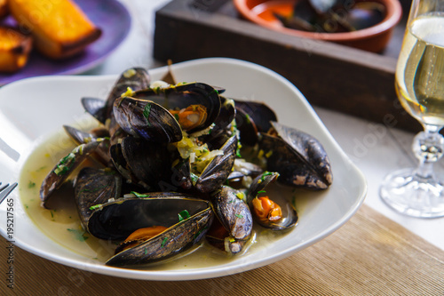 Freshly prepared mussels with vegetables in wine close-up