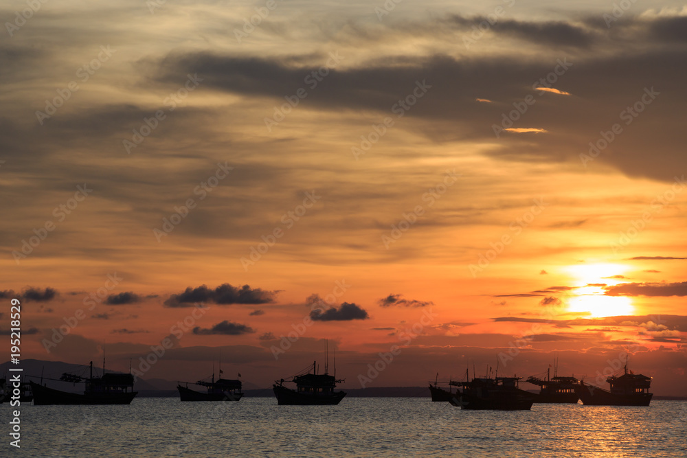 Vietnamese fishing boat silhouettes in sea at sunset Vietnamese fishing boat silhouettes in sea at sunset