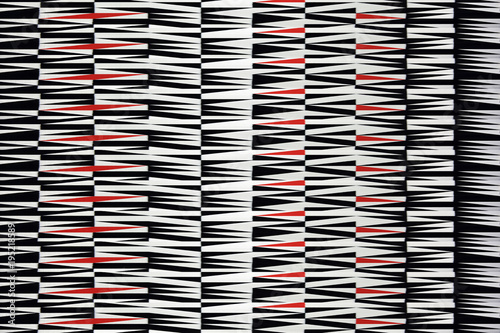 Piękny dywan, geometryczne wzory, białe, czarne i czerwone.