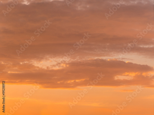 Fiery orange very beautiful sunset sky. Dramatic clouds after rain