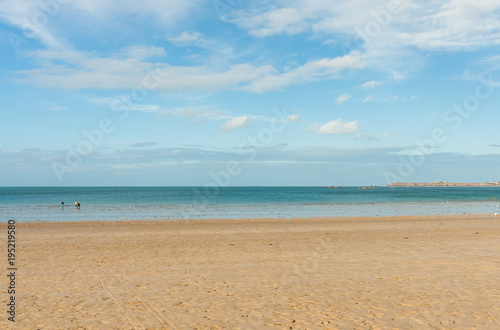 Sandy beach and blue sea on bright sunny day