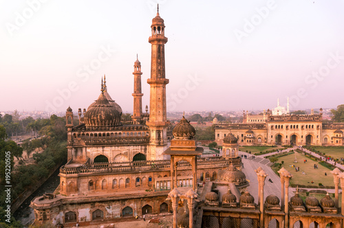 domed roof and towers of Asfi mosque shot at sunset from the rooftop of bara imambara in lucknow uttar pradesh india. This marvel of mughal architecture is a famous tourist destination photo