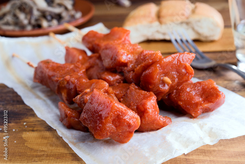skewer of raw marinated meat on wood photo