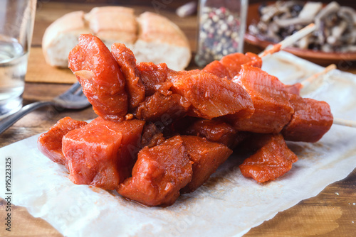 skewer of raw marinated meat on wood