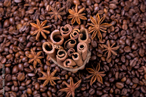 Coffee beans and cinnamon on a background of burlap. ,