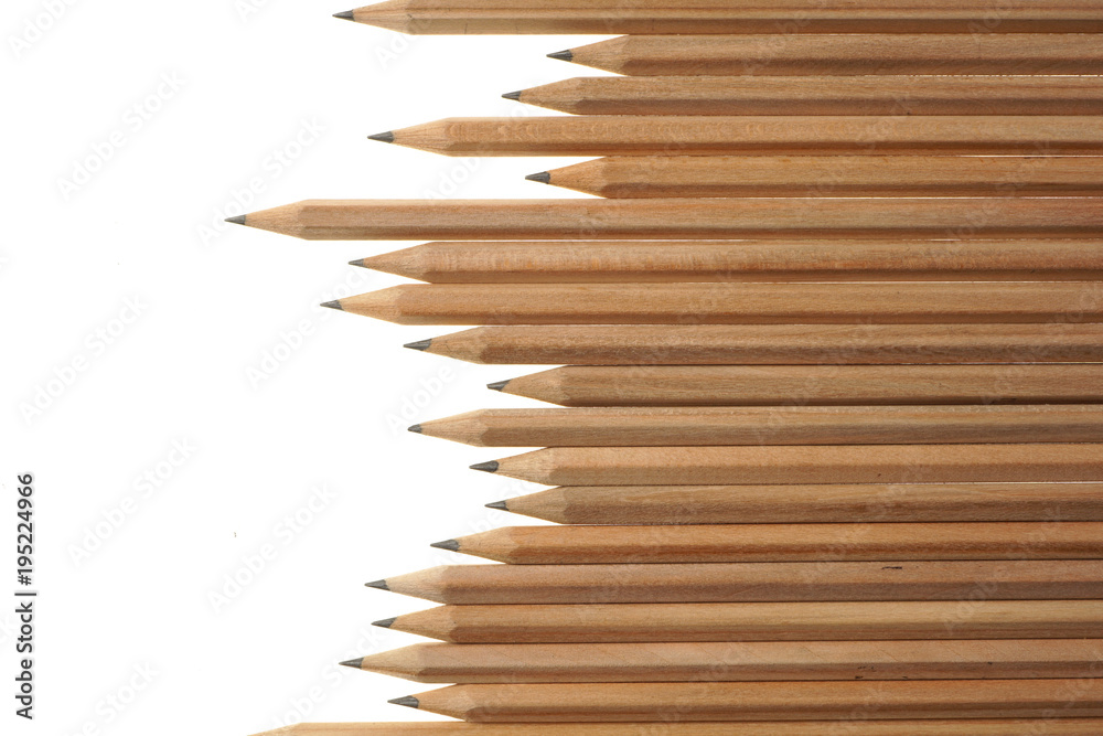 Fototapeta premium Bunch of identical graphite pencils on white background