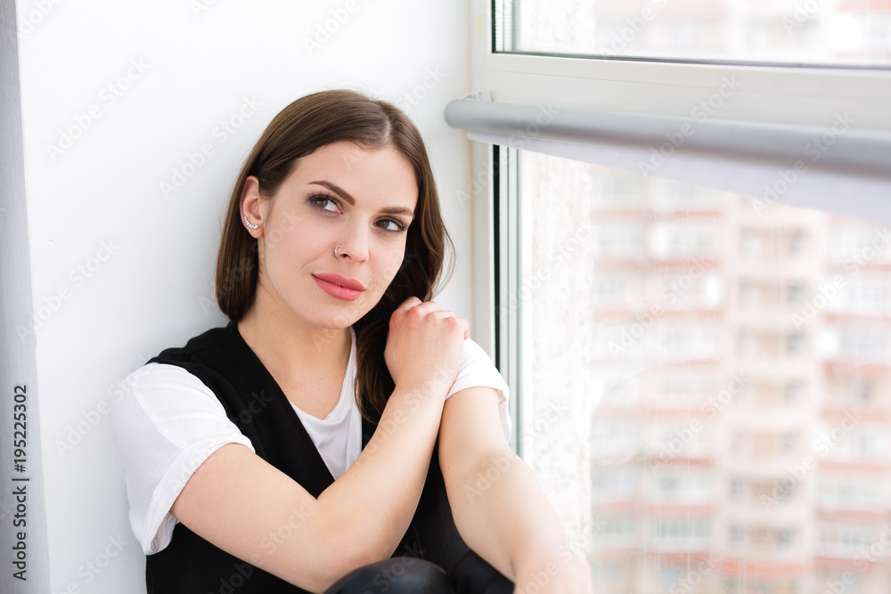 Woman sitting by the window Woman sitting by the window