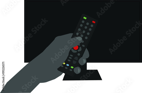 Ludzka ręka trzymająca pilota od telewizor, w tle duży telewizor. 