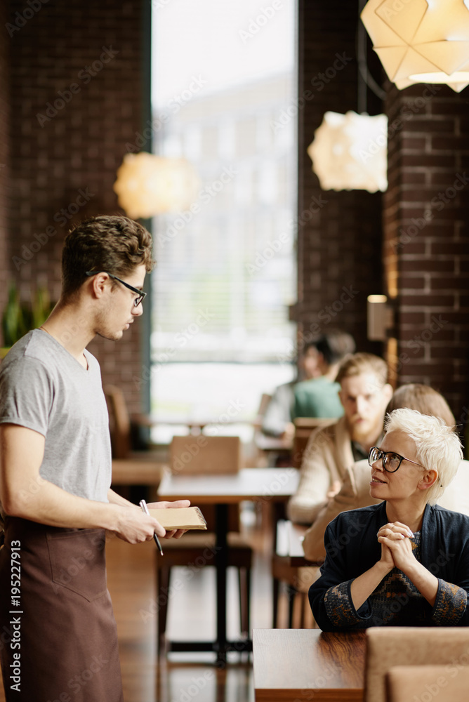 Waiter taking order from stylish customer Waiter taking order from stylish customer