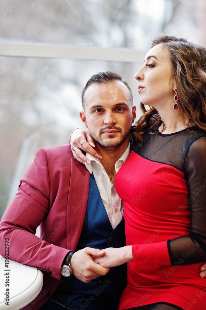 Couple in red love each other at restaurant indoor. Couple in red love each other at restaurant indoor.