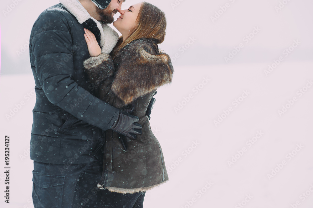 beautiful couple in love on the background of the winter sky. isolated beautiful couple in love on the background of the winter sky. isolated